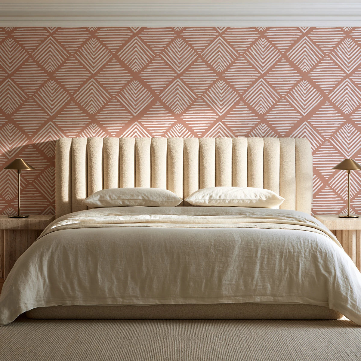 Chevron Etch Clay geometric diamond wallpaper behind a channel-tufted bed in a calm primary bedroom