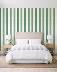Citrine Column Emerald stripe wallpaper behind a queen bed in a bright coastal bedroom