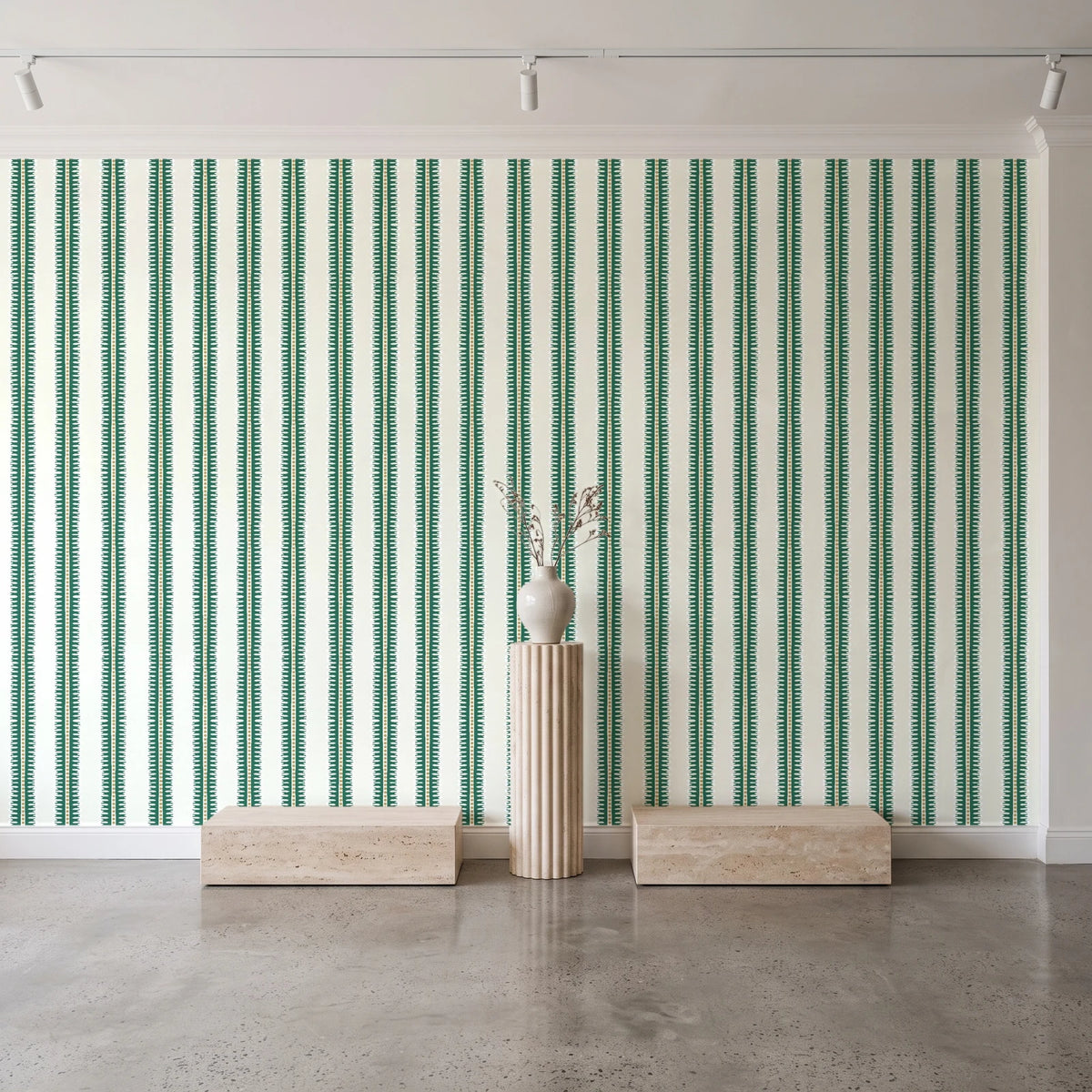 Citrine Column Emerald stripe wallpaper behind a travertine pedestal and vase in a minimal boutique