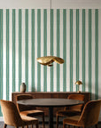 Citrine Column Emerald stripe wallpaper behind a walnut credenza and round table in an elegant dining room