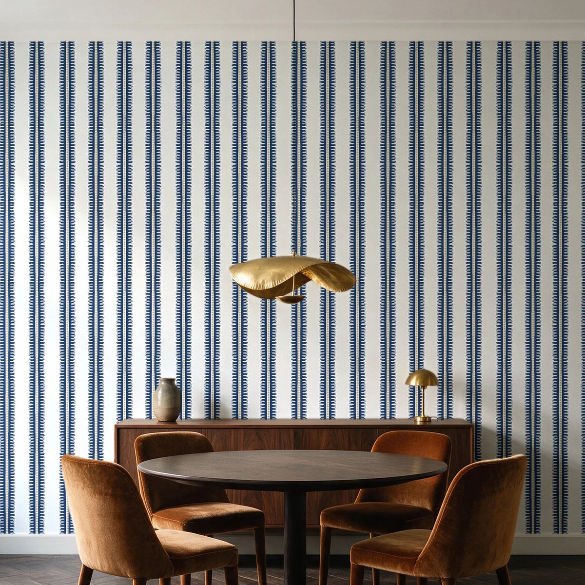 Citrine Column Navy stripe wallpaper behind a walnut credenza and round table in an elegant dining room