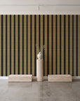 Citrine Column Noir stripe wallpaper behind a travertine pedestal and vase in a minimal boutique