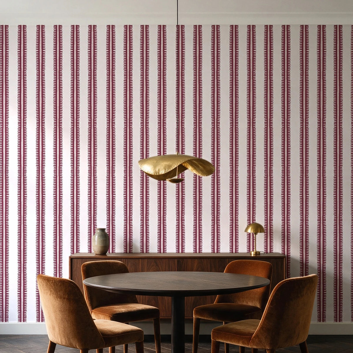 Citrine Column Oxblood stripe wallpaper behind a walnut credenza and round table in an elegant dining room