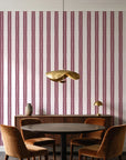 Citrine Column Oxblood stripe wallpaper behind a walnut credenza and round table in an elegant dining room