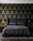 Clipped Dreams Noir tree wallpaper behind a tufted headboard in a dark, moody bedroom