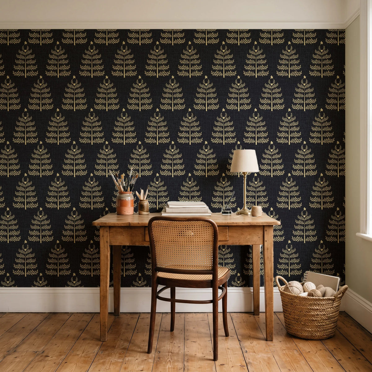 Clipped Dreams Noir tree wallpaper behind a vintage writing desk in a cozy craft-room home office