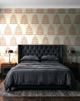 Clipped Dreams Terracotta tree wallpaper behind a tufted headboard in a dark, moody bedroom