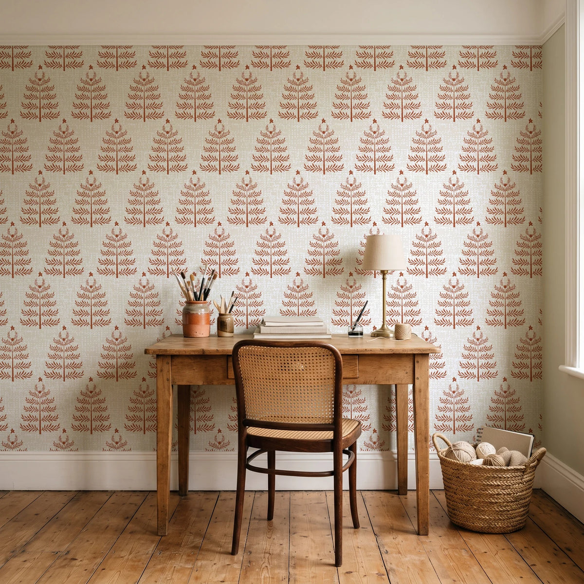 Clipped Dreams Terracotta tree wallpaper behind a vintage writing desk in a cozy craft-room home office