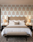 Clipped Dreams Terracotta tree wallpaper behind the headboard of a king bed in a contemporary hotel guest room