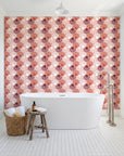 Coastal Scallop Blush scallop shell wallpaper behind a freestanding tub in a bright coastal bathroom