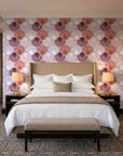 Coastal Scallop Blush scallop shell wallpaper behind the headboard of a king bed in a contemporary hotel guest room