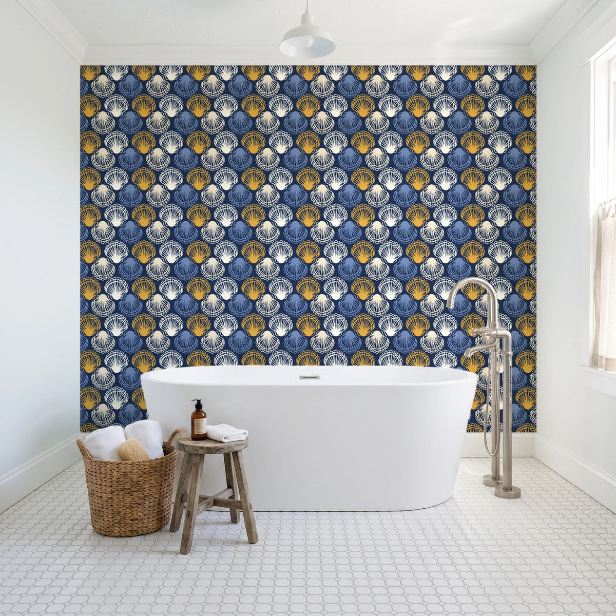 Coastal Scallop Navy scallop shell wallpaper behind a freestanding tub in a bright coastal bathroom