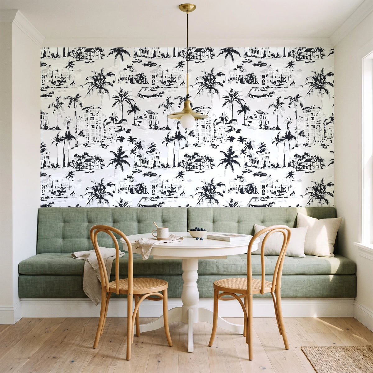 Coastal Village Charcoal palm toile wallpaper as a feature wall in a sunlit breakfast nook