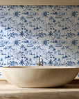 Coastal Village Navy palm toile wallpaper creating ambiance in a serene spa bathroom
