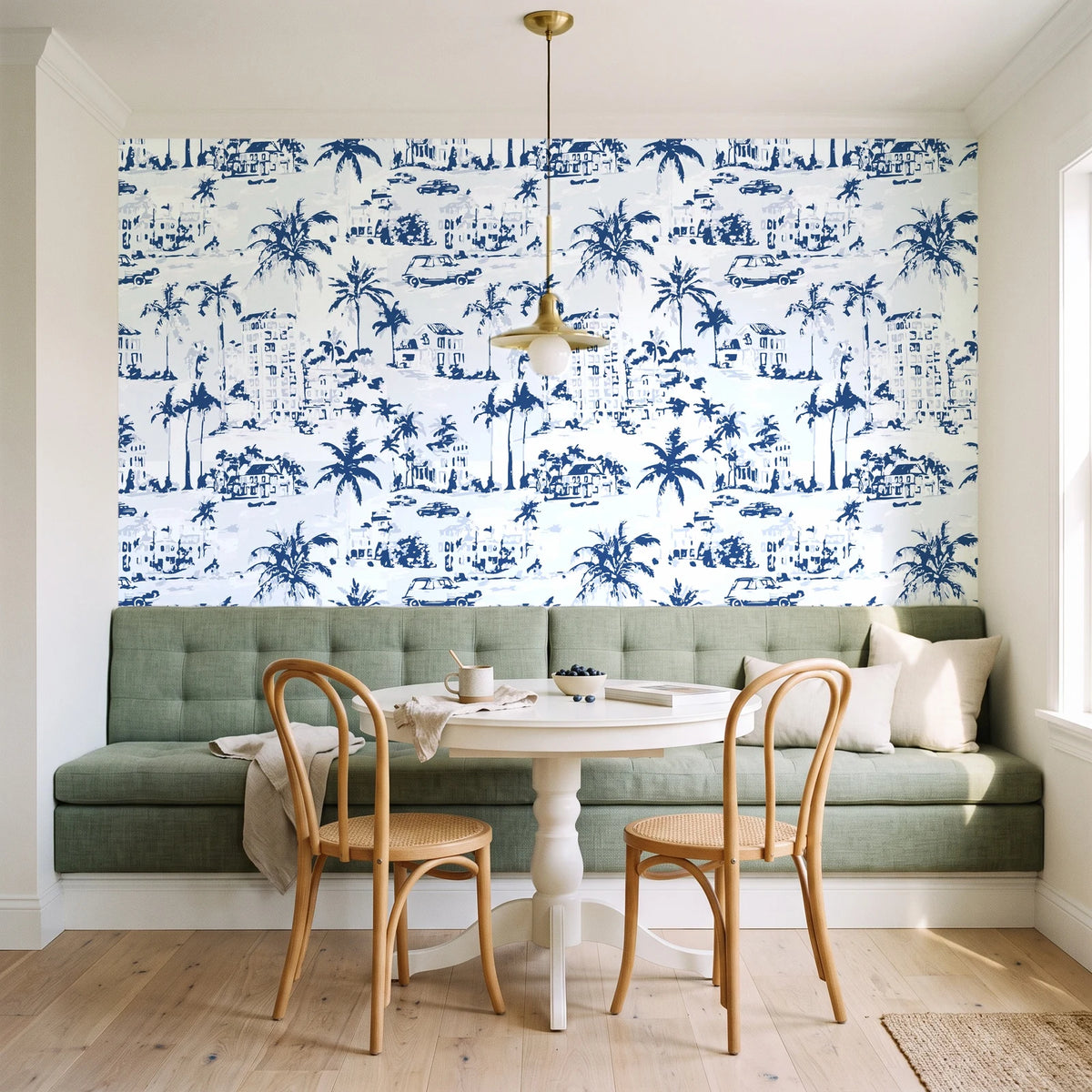 Coastal Village Navy palm toile wallpaper as a feature wall in a sunlit breakfast nook