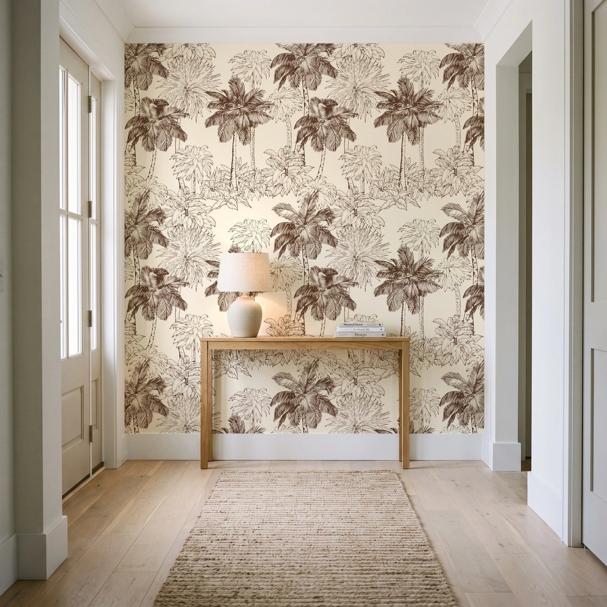 Conservatory Greens Chestnut tropical palm toile wallpaper behind a console table in a light entry hallway