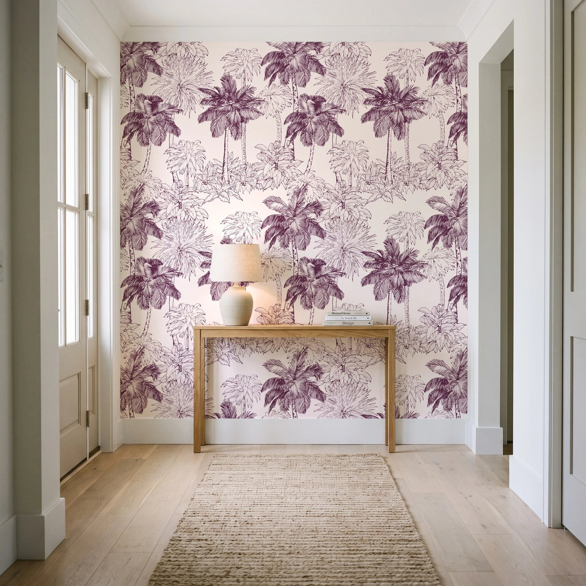 Conservatory Greens Mulberry tropical palm toile wallpaper behind a console table in a light entry hallway