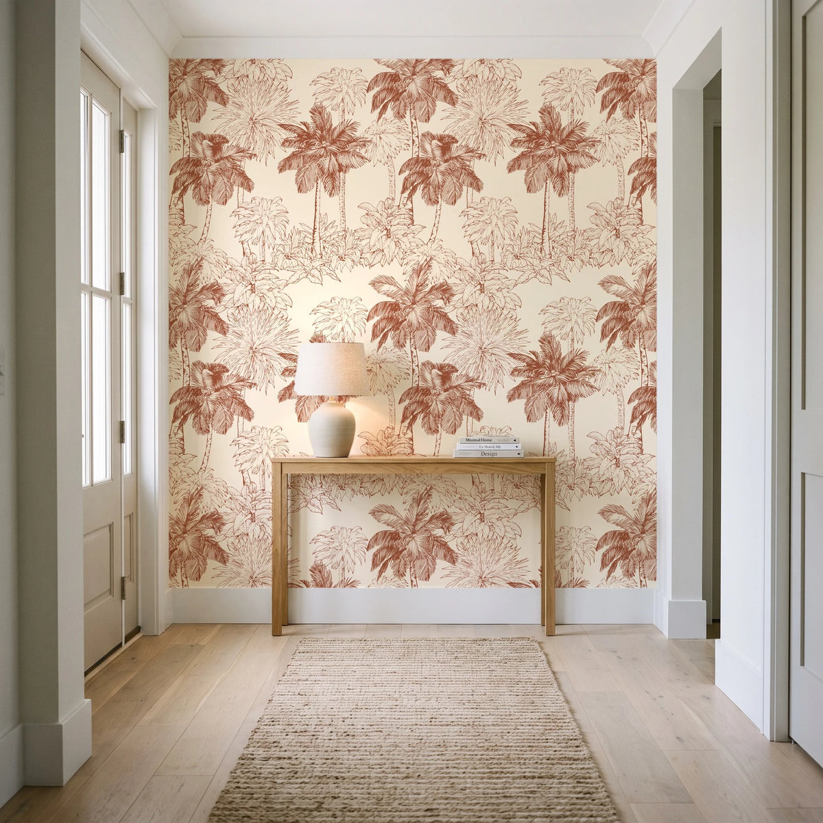 Conservatory Greens Terracotta tropical palm toile wallpaper behind a console table in a light entry hallway