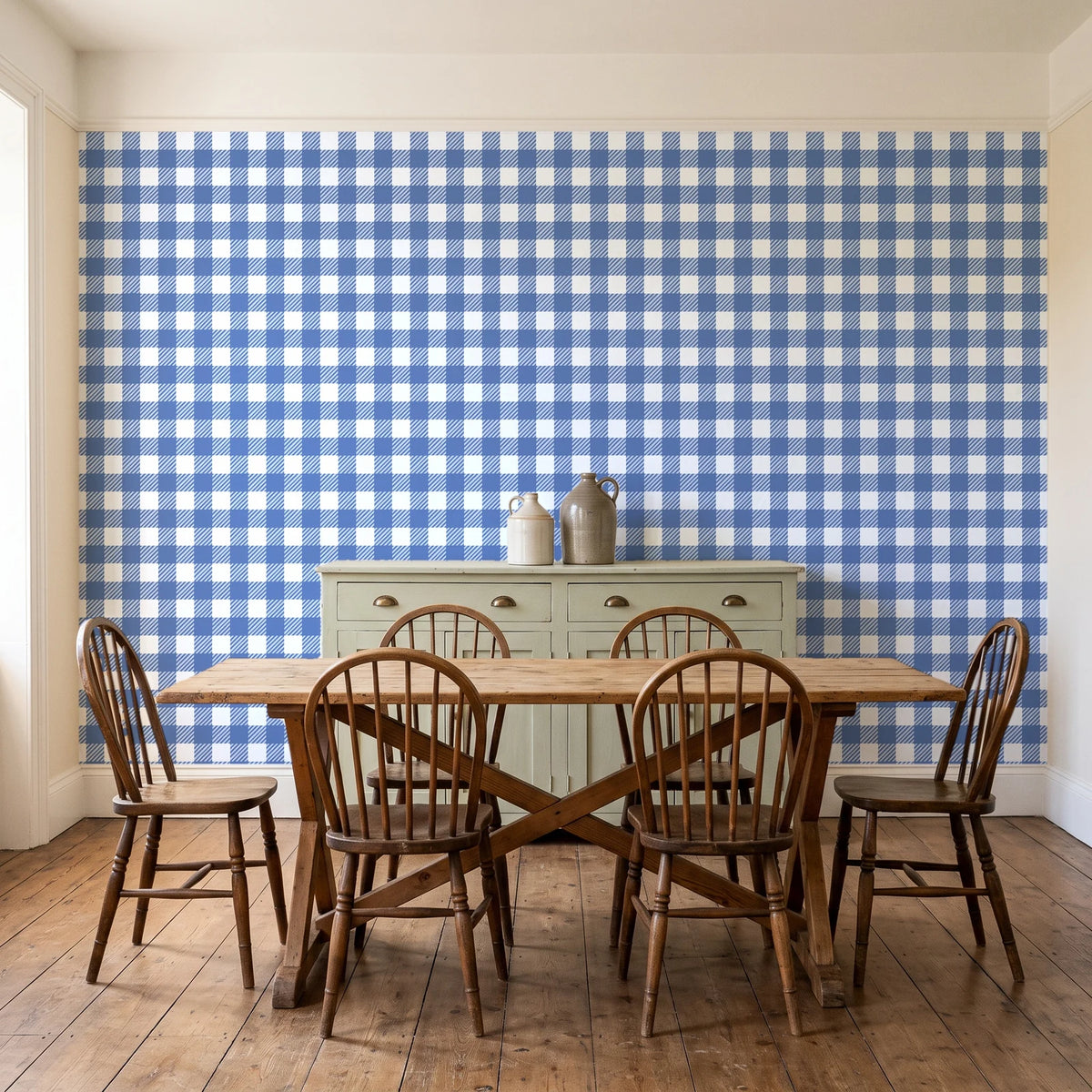 Cotton Candy Navy gingham wallpaper in a farmhouse dining room with a sage sideboard and rustic trestle table