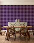 Cotton Candy Plum gingham wallpaper in a farmhouse dining room with a sage sideboard and rustic trestle table