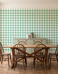 Cotton Candy Sage gingham wallpaper in a farmhouse dining room with a sage sideboard and rustic trestle table