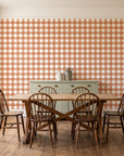 Cotton Candy Terracotta gingham wallpaper in a farmhouse dining room with a sage sideboard and rustic trestle table