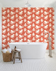 Cresting Wave Coral octopus wallpaper behind a freestanding tub in a bright coastal bathroom
