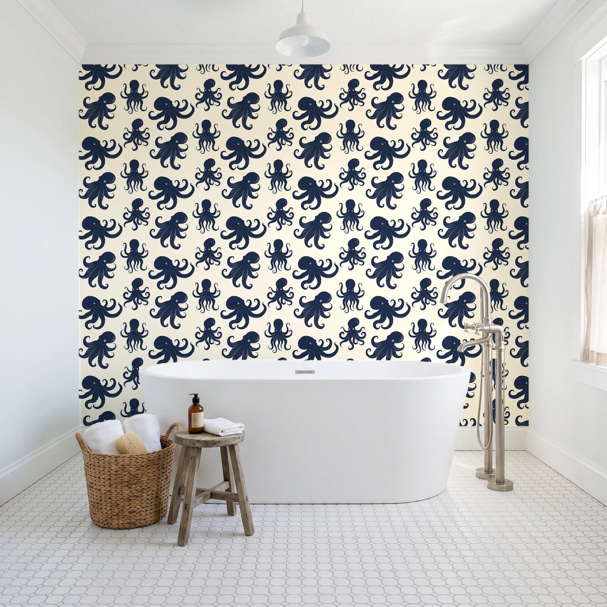 Cresting Wave Ink octopus wallpaper behind a freestanding tub in a bright coastal bathroom