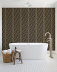 Crossroads Noir geometric wallpaper behind a freestanding tub in a bright coastal bathroom