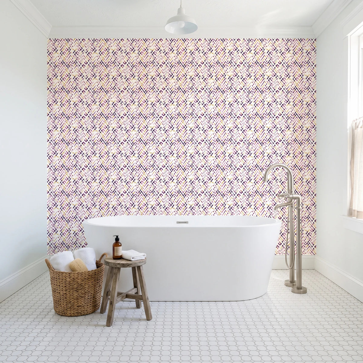 Crossroads Plum geometric wallpaper behind a freestanding tub in a bright coastal bathroom