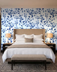 Desert Bloom Indigo botanical vine wallpaper behind the headboard of a king bed in a contemporary hotel guest room