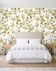 Desert Bloom Ochre botanical vine wallpaper behind a queen bed in a bright coastal bedroom