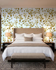 Desert Bloom Ochre botanical vine wallpaper behind the headboard of a king bed in a contemporary hotel guest room