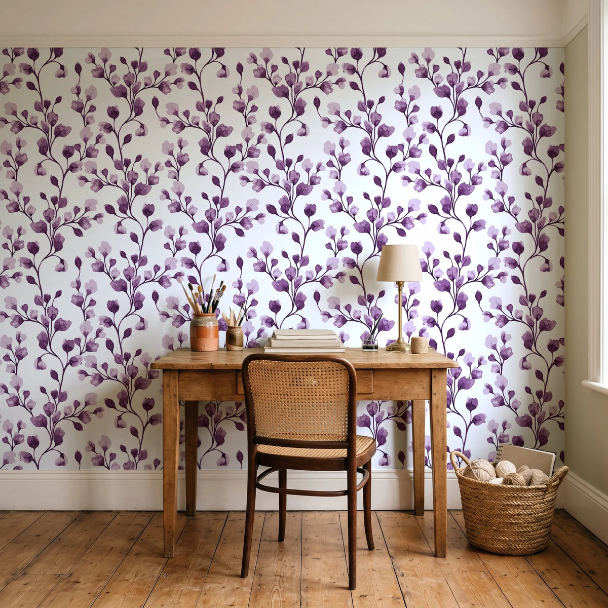 Desert Bloom Plum botanical vine wallpaper behind a vintage writing desk in a cozy craft-room home office