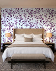 Desert Bloom Plum botanical vine wallpaper behind the headboard of a king bed in a contemporary hotel guest room
