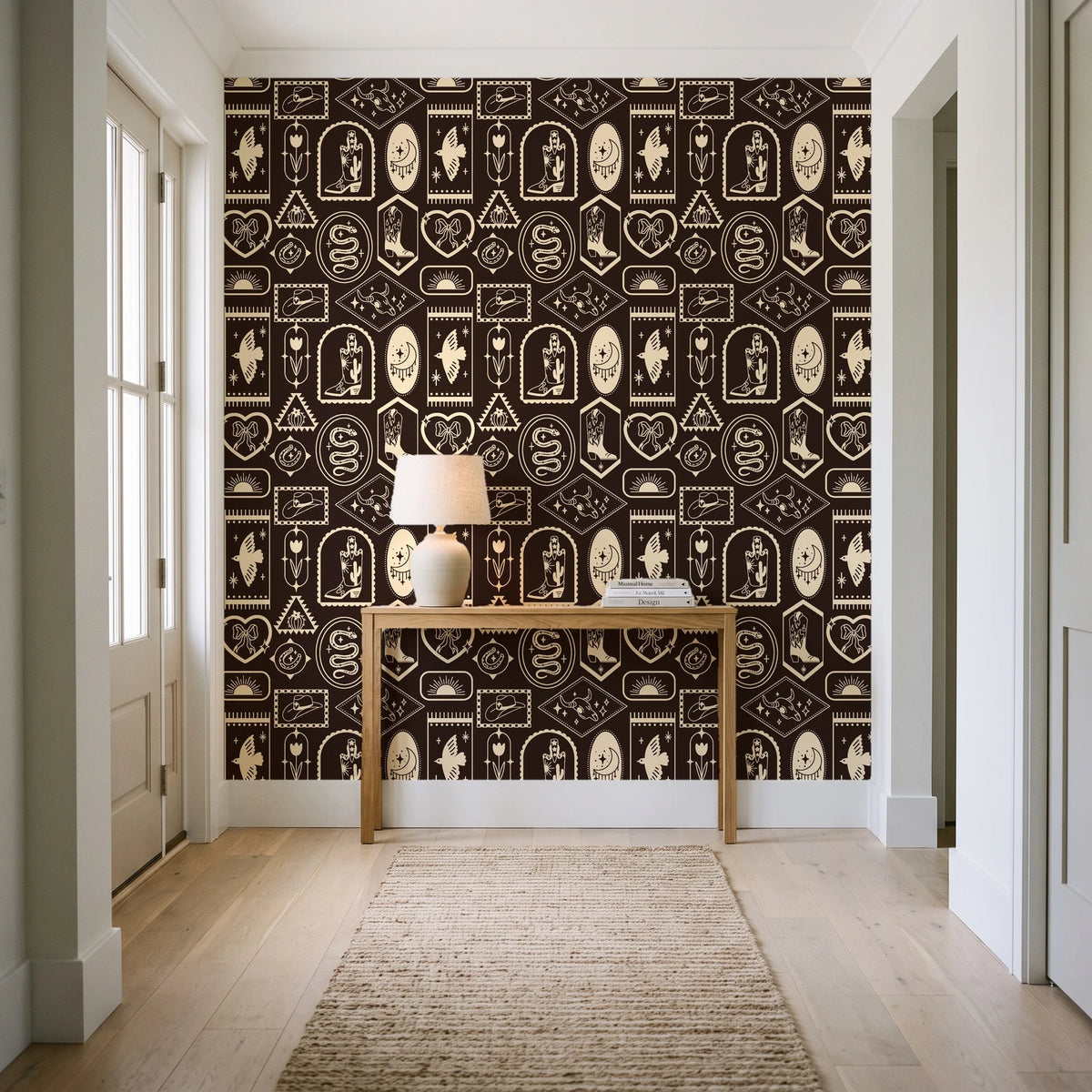 Desert Charms Espresso western icon wallpaper behind a console table in a light entry hallway