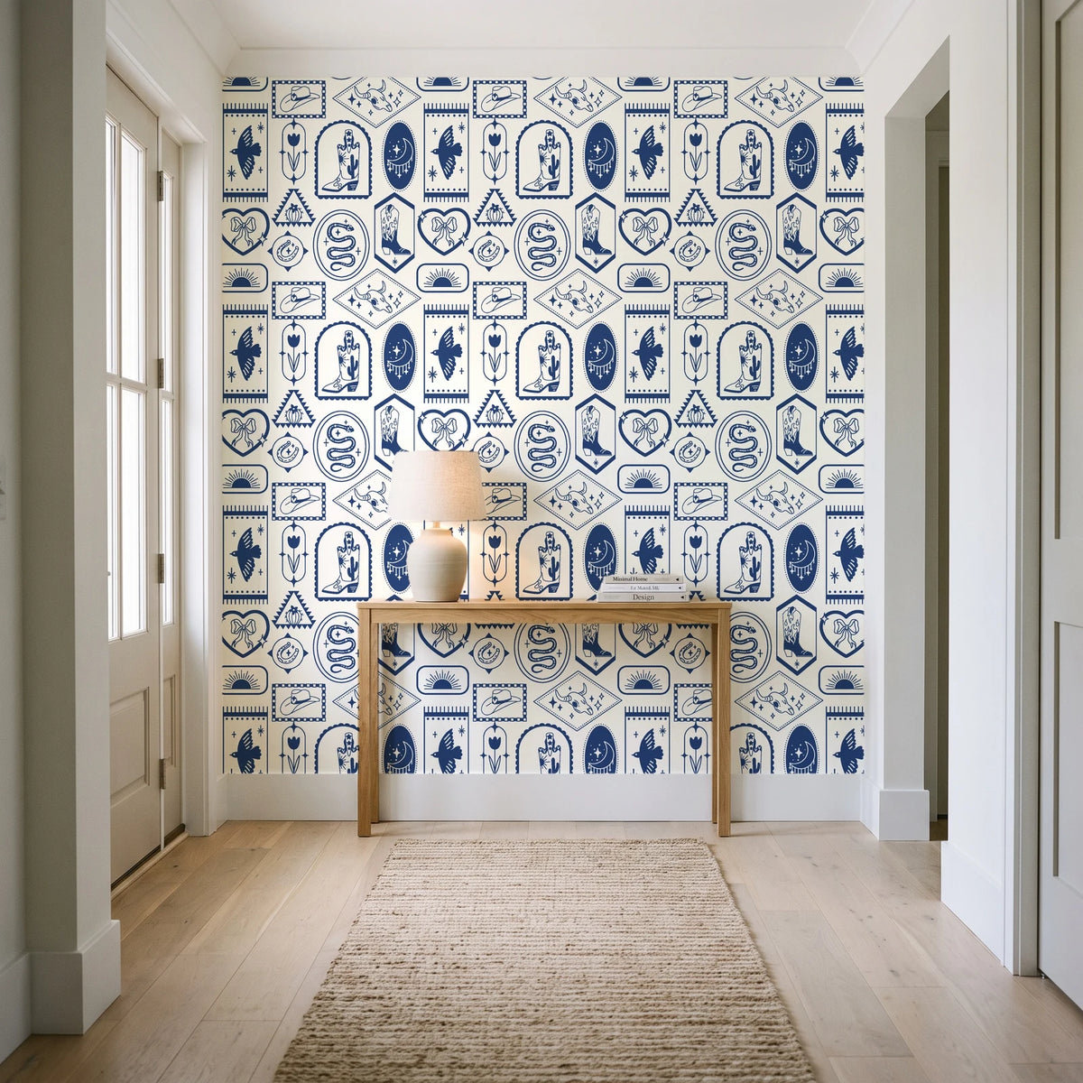Desert Charms Indigo western icon wallpaper behind a console table in a light entry hallway