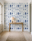 Desert Charms Indigo western icon wallpaper behind a console table in a light entry hallway