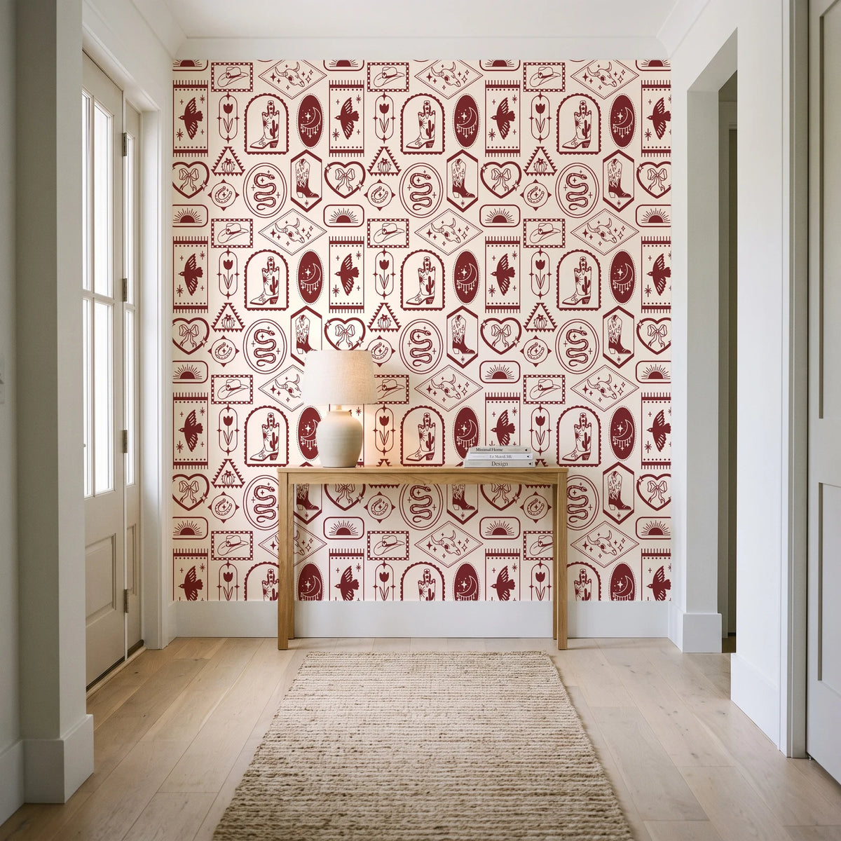 Desert Charms Oxblood western icon wallpaper behind a console table in a light entry hallway