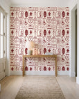 Desert Charms Oxblood western icon wallpaper behind a console table in a light entry hallway