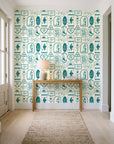 Desert Charms Turquoise western icon wallpaper behind a console table in a light entry hallway
