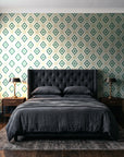 Desert Compass Emerald geometric diamond wallpaper behind a tufted headboard in a dark, moody bedroom