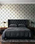 Desert Compass Navy geometric diamond wallpaper behind a tufted headboard in a dark, moody bedroom