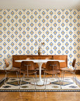 Desert Compass Navy geometric diamond wallpaper in a mid-century dining room with a teak sideboard and tulip table
