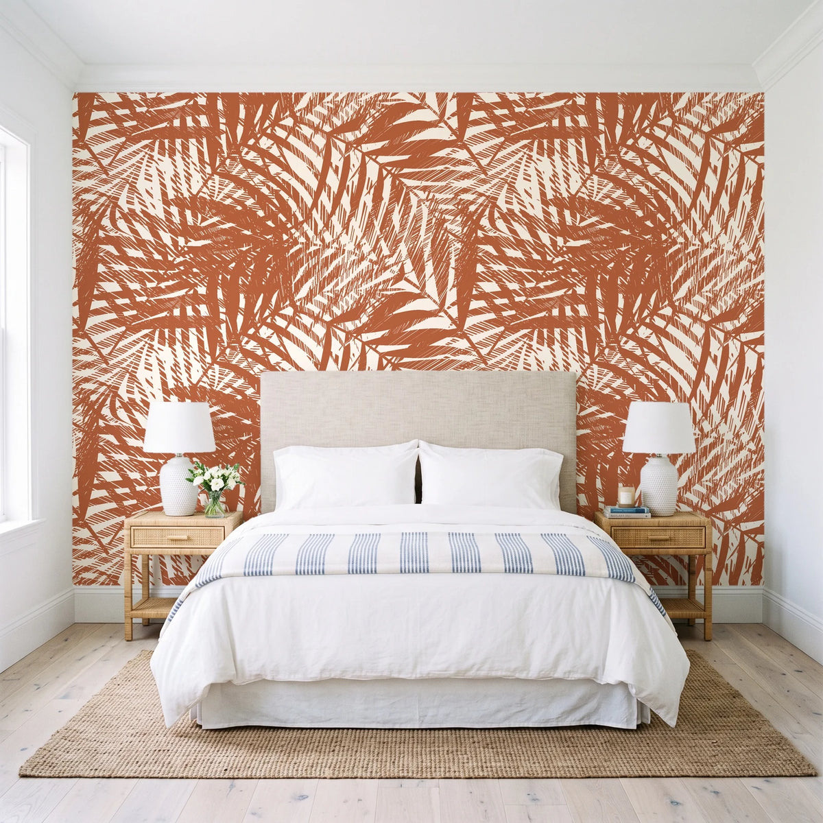 Desert Frond Clay palm frond wallpaper behind a queen bed in a bright coastal bedroom