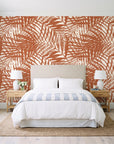 Desert Frond Clay palm frond wallpaper behind a queen bed in a bright coastal bedroom