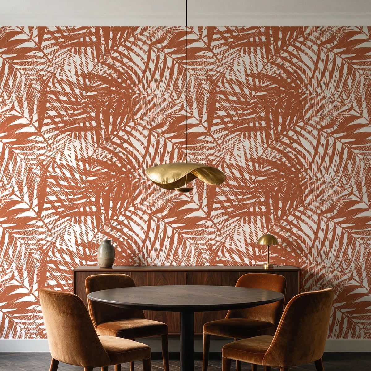 Desert Frond Clay palm frond wallpaper behind a walnut credenza and round table in an elegant dining room