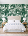 Desert Frond Emerald palm frond wallpaper behind a queen bed in a bright coastal bedroom