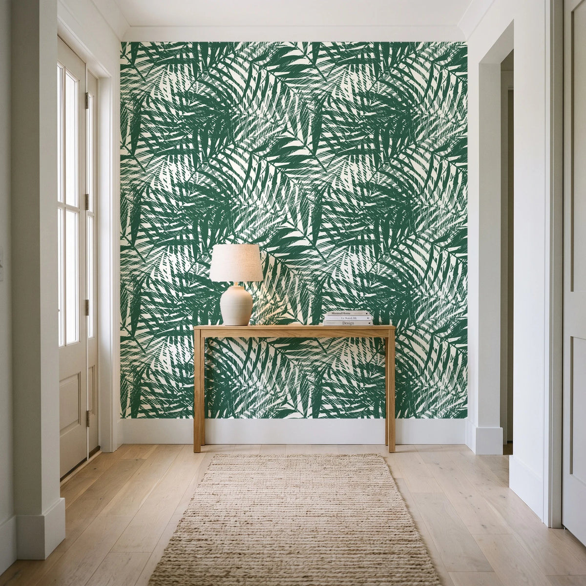 Desert Frond Emerald palm frond wallpaper behind a console table in a light entry hallway