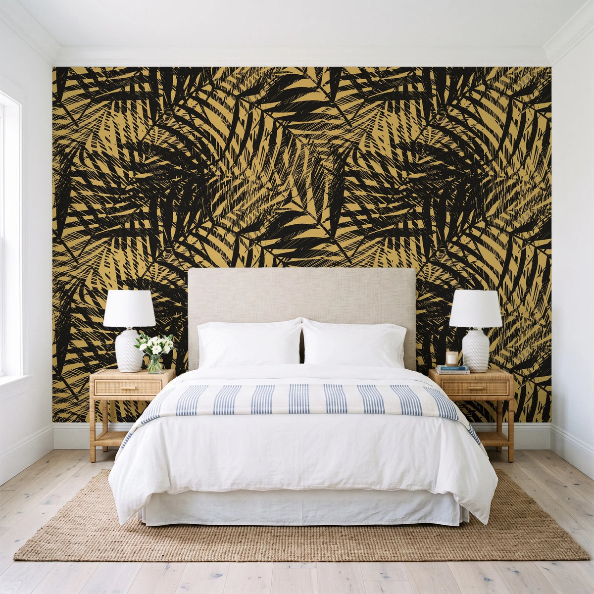 Desert Frond Gilt palm frond wallpaper behind a queen bed in a bright coastal bedroom